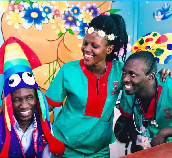 Photo of happy Whisper staff, one wearing a clown hat