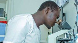 Photo of lab technician and microscope