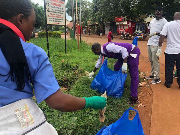 Photo of Whisper staff collecting {snippet us|litter|garbage} in the street